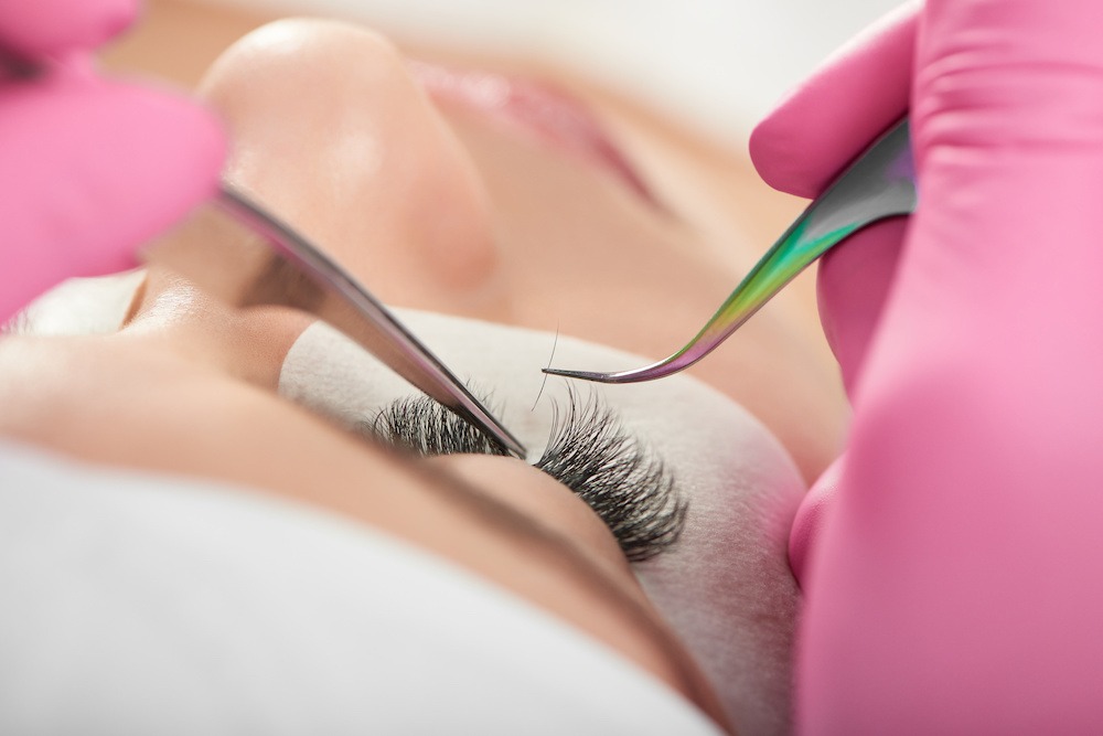 young woman receiving lash extension treatment