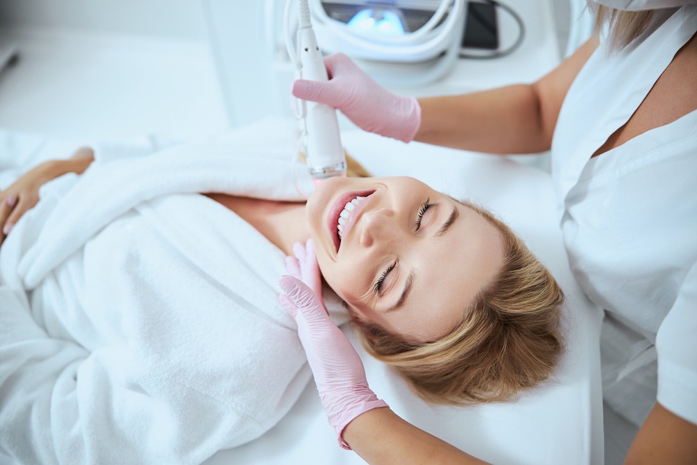 young woman receiving microneedling treatment